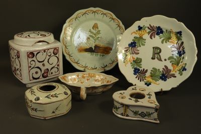 many different types of decorative plates and bowls on the table