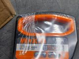 an orange and black tool sitting on top of a table next to a brown box
