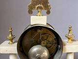 a clock that is sitting on a stand on a table