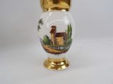 a vase with a picture of a house on it