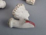 a small figurine of a woman with a red nose