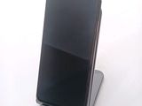 a cell phone that is sitting on top of a stand