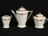 three pieces of porcelain tea and coffee set on a black background