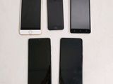 three iphones are sitting next to each other on a table