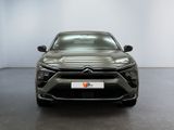 the front view of a grey car in a white room