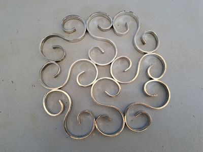a lot of silver rings arranged in a circle on a table