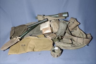a bag with a baseball bat and other items on it