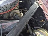 a close up of a car ' s engine with the hood open
