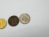 three different types of coins on a white surface