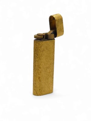 a gold lighter on a white background
