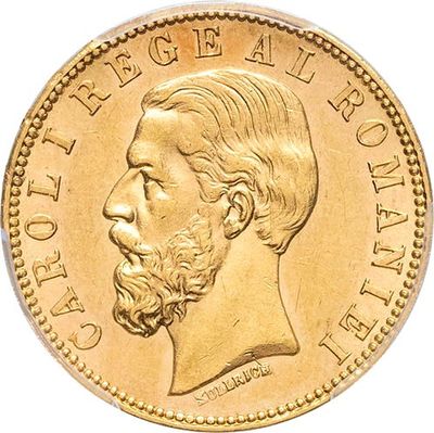 a close up of a gold coin with a man ' s face