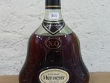 a bottle of alcohol sitting on top of a wooden table