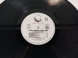 a black record with a label on it sitting on a table