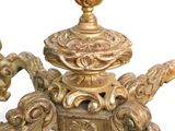 a gold table with a candle holder on top of it