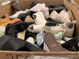 a cardboard box filled with shoes and other items