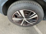a close up of a tire on a car in a parking lot