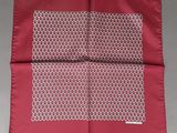a close up of a red and white handkerchief on a table