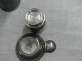 a silver tea pot and a silver tea pot on a table
