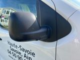 a side view of a white van with a black side mirror