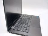 a laptop that is open on a white surface