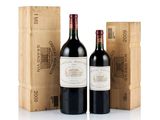 three bottles of red wine sitting next to a wooden box
