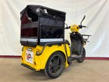 a yellow motorcycle with a black box on the back of it