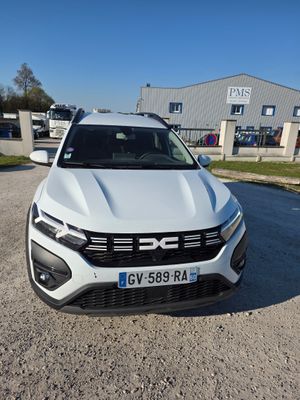 un SUV Volkswagen blanc garé devant un immeuble