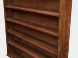 a wooden bookcase with four shelves on each side