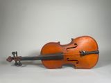 an old violin sitting on top of a white table next to a white wall