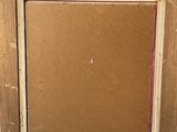 an old picture frame is sitting on top of a wooden table