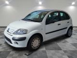 a picture of a small white car parked on a checkered floor