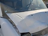 a white van that is sitting in the dirt
