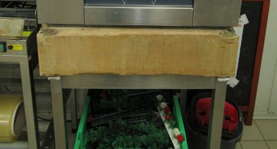 an image of a kitchen with a microwave on a cart