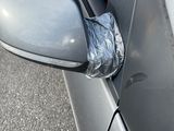 a car door mirror with a piece of tin foil on the side of it