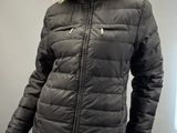 a mannequin mannequin wearing a black jacket with a fur collar