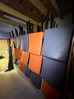 several orange and blue refrigerators are lined up in a room