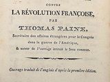 an old book with black writing on it sitting on top of a table