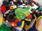 a pile of legos in a plastic bag on the floor