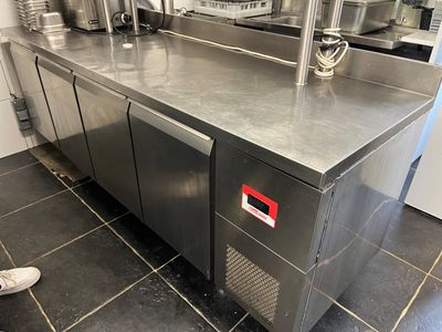 a stainless steel counter top in a kitchen with stainless steel appliances