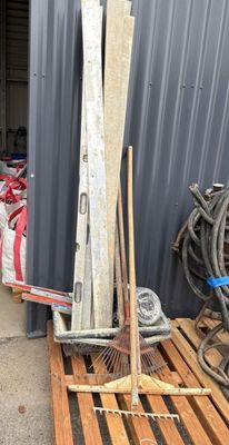 a pile of skis and ski poles in front of a building