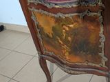 a cabinet that has a painting on the front of it