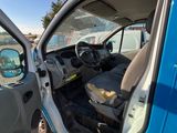 a blue van that has the door open and the driver ' s seat down