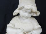 marble statue of a young girl sitting on a stool writing a book