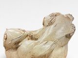 a statue of a woman laying down on a pillow