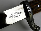 a close up of a knife with a metal handle