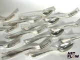 a lot of spoons that are sitting on a table