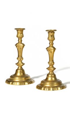 pair of antique brass candlesticks on a white background
