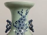 a blue and white vase sitting on a table