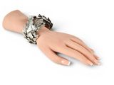 bracelet with silver metal flowers on a mannequin hand on a white background