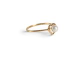 a gold ring with a pearl in the middle